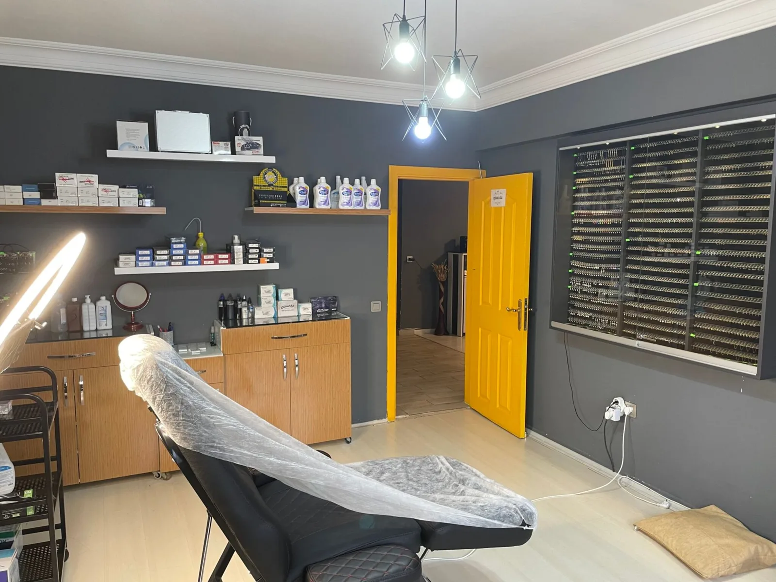 The fitting room: chair, supply shelves and the jewellery wall