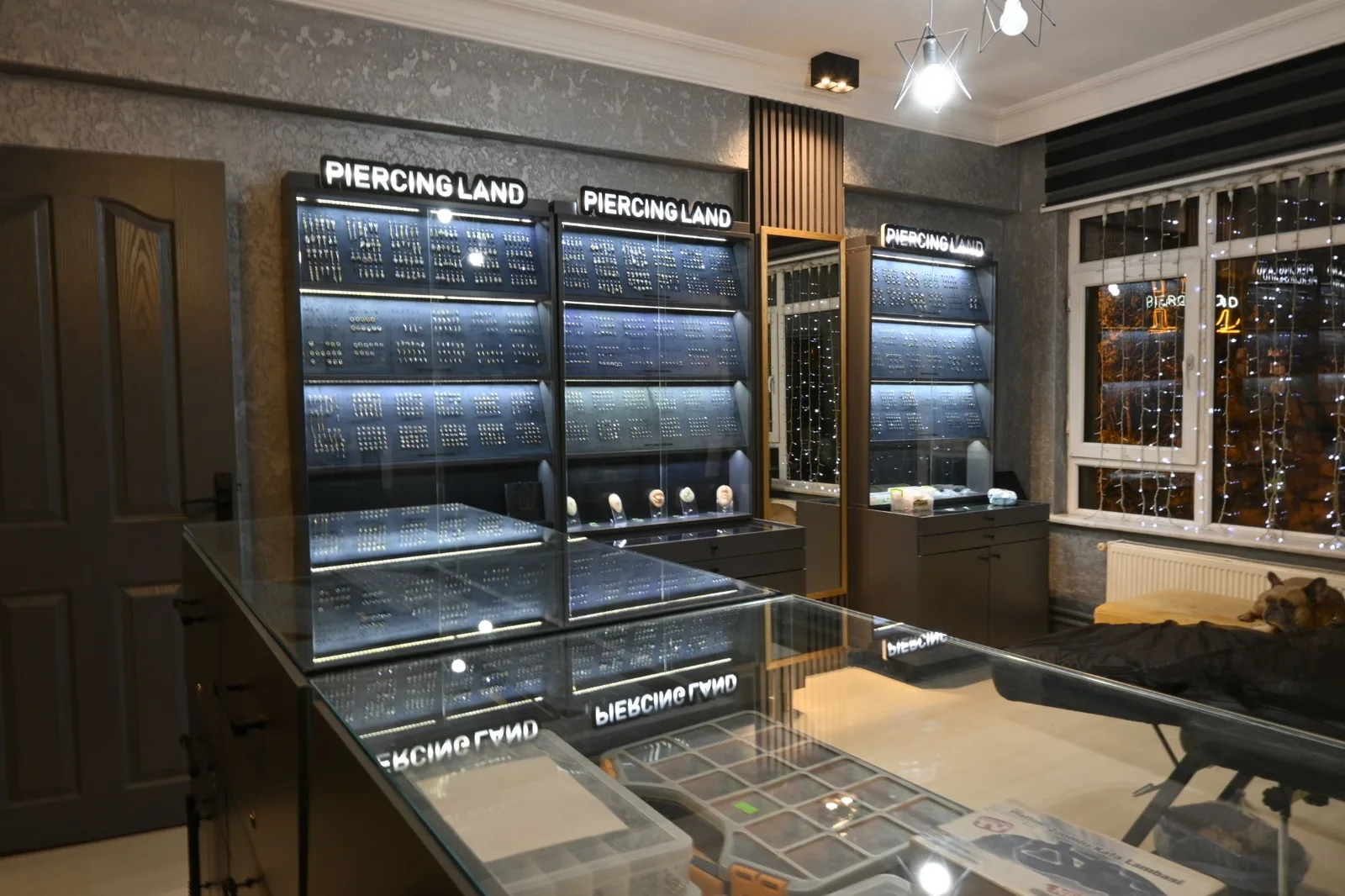 The lit PiercingLand display cabinets